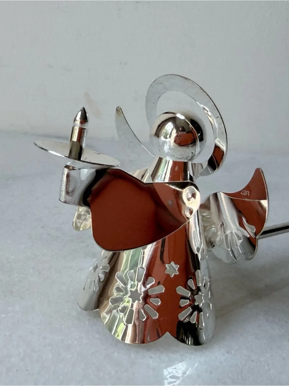 silver-tone angel candle snuffer features intricate, cutout wing and robe